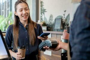 Woman use smartphone to scan QR code to pay in cafe restaurant with a digital payment without cash. Choose menu and order accumulate discount. E wallet, technology, pay online, credit card, bank app. photo