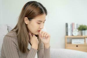 sick woman with a headache and feeling cold on sofa, female sneezing and runny nose with seasonal influenza, allergic, high fever and influenza, resting, virus, coronavirus, feel illness, respiratory photo