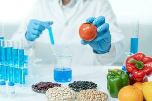 Scientist check chemical food residues in laboratory. Control experts inspect quality of fruits, vegetables. lab, hazards, ROHs, find prohibited substances, contaminate, Microscope, Microbiologist photo