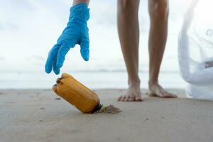 Save ocean. Volunteer pick up trash garbage at the beach and plastic bottles are difficult decompose prevent harm aquatic life. Earth, Environment, Greening planet, reduce global warming, Save world photo