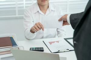 Businessmen receive salary or bonuses from management or Boss. Company give rewards to encourage work. Smiling businessman enjoying a reward at the desk in the office. photo