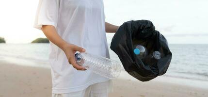 Save water. Volunteer pick up trash garbage at the beach and plastic bottles are difficult decompose prevent harm aquatic life. Earth, Environment, Greening planet, reduce global warming, Save world photo