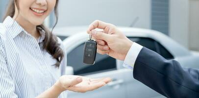 lease, rental car, sell, buy. Dealership manager send car keys to the new owner.  Sales, loan credit financial, rent vehicle, insurance,  renting, Seller, dealer, installment, car care business photo