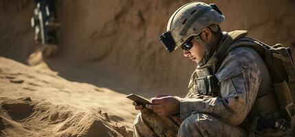 Handsome young soldier using digital tablet while sitting on dirt road AI Generated photo