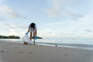 Save water. Volunteer pick up trash garbage at the beach and plastic bottles are difficult decompose prevent harm aquatic life. Earth, Environment, Greening planet, reduce global warming, Save world photo