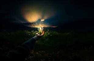 Hand holding a light bulb on nature background with the concept of natural energy. AI Generative. photo