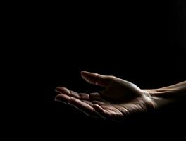 Human hand on dark background on empty space for text. Generative AI. photo