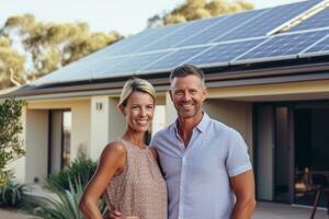 Couple stands smiling in the driveway of a house with solar panels installed. Concept solar renewable energy. Generative AI photo