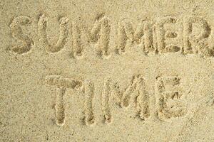 sand with summer time hand lettering photo