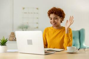 African american girl using laptop computer having video chat at home. Young woman having virtual meeting online chat video call conference. Work learning from home, remote teacher. photo