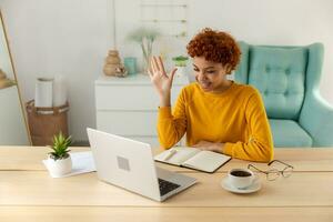 African american girl using laptop computer having video chat at home. Young woman having virtual meeting online chat video call conference. Work learning from home, remote teacher. photo