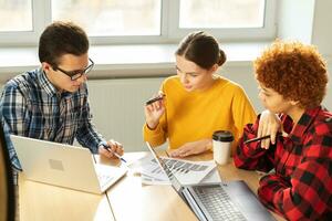 Focused female team leader discuss financial statistics brainstorming business meeting with partners clients at office. Lady boss leader young businesswoman. Diverse corporate professional team. photo