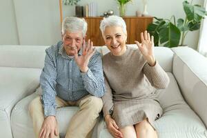 Happy senior woman man talk on video call with friends family. Mature old grandmother grandfather talking speaking with grown up children online. Older generation modern tech usage. Webcamera view. photo