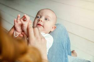 Newborn child lies on mother lap photo