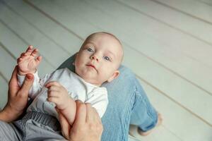 Newborn child lies on mother lap photo