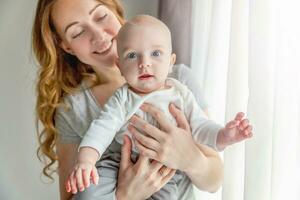 Young mother holding her newborn child photo