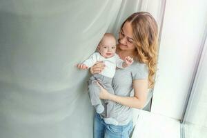 Young mother holding her newborn child photo