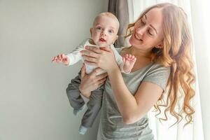 Young mother holding her newborn child photo