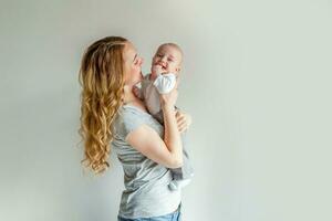 Young mother holding her newborn child photo