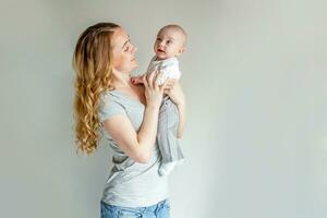 Young mother holding her newborn child photo