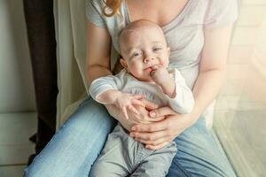 Young mother holding her newborn child photo