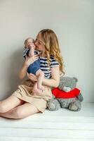 Young mother holding her newborn child photo