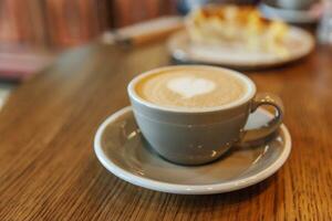 Coffee cup fresh cream organic cappuccino on table in cafe photo