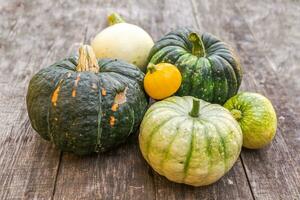 Autumnal Background. Natural autumn fall view pumpkins on wooden background. Inspirational october or september wallpaper. Change of seasons ripe organic food concept, Halloween party Thanksgiving day photo