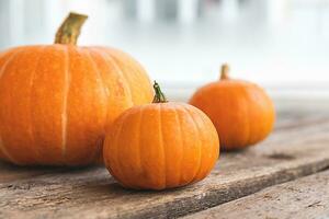 Autumnal Background. Natural autumn fall view pumpkins on wooden background. Inspirational october or september wallpaper. Change of seasons ripe organic food concept, Halloween party Thanksgiving day photo