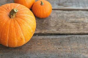 Autumnal Background. Natural autumn fall view pumpkins on wooden background. Inspirational october or september wallpaper. Change of seasons ripe organic food concept, Halloween party Thanksgiving day photo