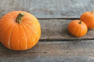 Autumnal Background. Natural autumn fall view pumpkins on wooden background. Inspirational october or september wallpaper. Change of seasons ripe organic food concept, Halloween party Thanksgiving day photo