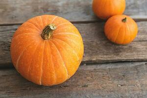 Autumnal Background. Natural autumn fall view pumpkins on wooden background. Inspirational october or september wallpaper. Change of seasons ripe organic food concept, Halloween party Thanksgiving day photo