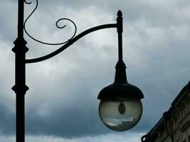 Retro lantern on the background of the blue sky. vintage lantern. A street lantern. Reflection on the surface of the lamp. photo