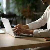 male office worker hand doing work with laptop on the desk in the office photo