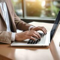 male office worker hand doing work with laptop on the desk in the office photo