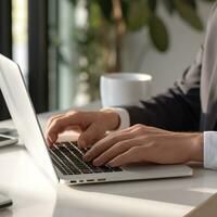 male office worker hand doing work with laptop on the desk in the office photo
