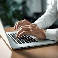 male office worker hand doing work with laptop on the desk in the office photo