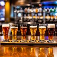 Flight of beer for tasting on a bar counter with a blurred background. photo