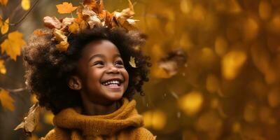 Happy Young African American Girl Playing in the Fall Leaves with Space for Copyspace for text photo