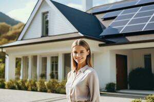 Happy young woman stands smiling of a house with solar panels installed,Generative AI. photo