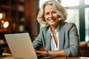 Happy mature adult business woman executive sitting at desk using laptop,Generative AI. photo