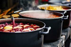 Beverages fruits and berries hot mulled wine in pots with steam in street food market. Generative AI photo