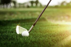 Golf ball close up on tee grass on blurred beautiful landscape of golf background. Concept international sport that rely on precision skills for health relaxation. photo