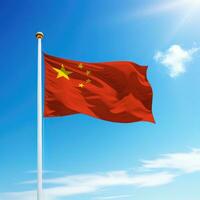 Waving flag of China on flagpole with sky background. photo