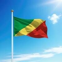 Waving flag of Congo on flagpole with sky background. photo