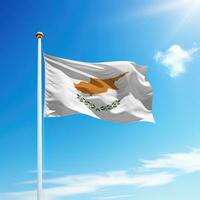 Waving flag of Cyprus on flagpole with sky background. photo