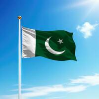 Waving flag of Pakistan on flagpole with sky background. photo