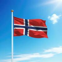 Waving flag of Norway on flagpole with sky background. photo