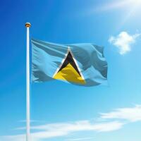 Waving flag of Saint Lucia on flagpole with sky background. photo