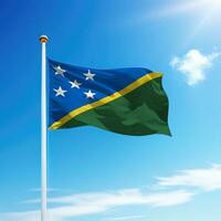 Waving flag of Solomon Islands on flagpole with sky background. photo